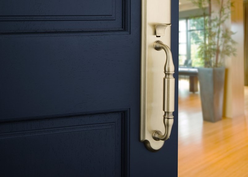 brass door pull on navy blue door
